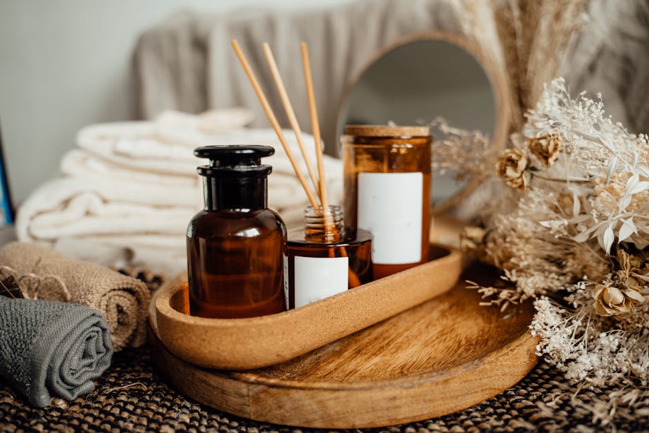 A tranquil spa setup featuring aromatherapy oils, candles, and dried flowers for relaxation